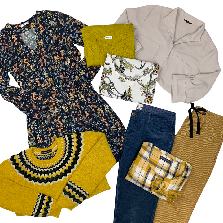 A variety of women's clothing items laid out, including floral tops, a beige cardigan, a yellow sweater, and plaid pants.